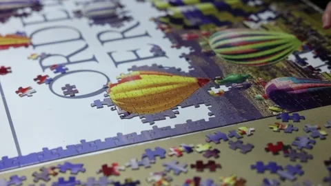 Close-up shot of a couple of hands placing jigsaw pieces together Stock Footage 294151813