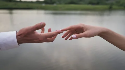 Close-up shot of a couple's hands gently touching on beach, summer love. Stock Footage 217742165