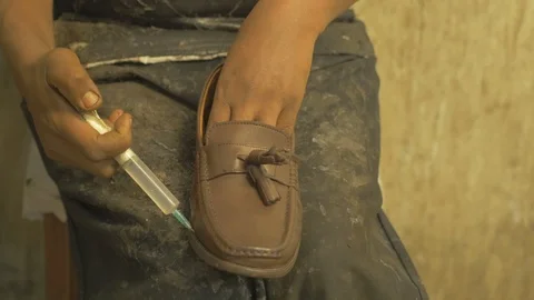 Close up shot of Crafts man working on the final steps of shoe making Stock Footage 108831646