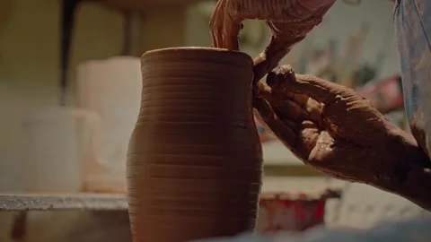Close up shot craftsman making relief on surface of ceramic jug. Spinning clay Stock Footage 259497774