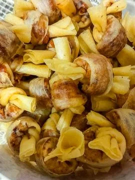A close-up shot of crispy fried spring rolls or "Popia" knots Stock Photos