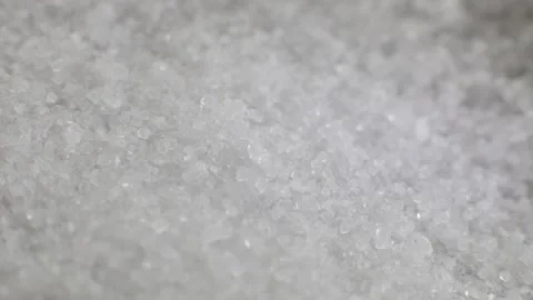 Close-up shot of crystals of salt falling on a stainless steel surface of a spoo Stock Footage 205518859