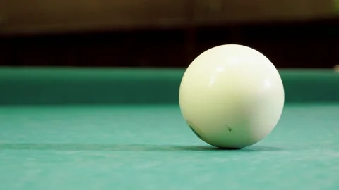 Close-up shot of cue hitting the white ball into pocket on billiard table. 4K Video stock 110296004