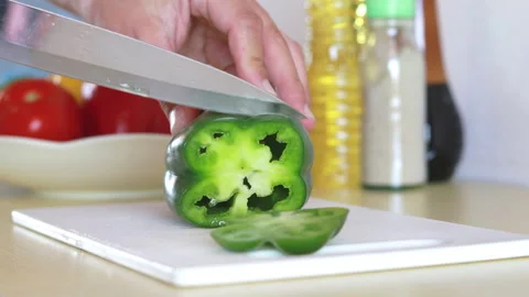 Close up shot of culinary master is cutting Green bell pepper to be prepared Stock Footage 150498974