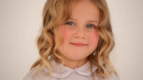 Close up shot of cute small nice little girl child toddler with rosy cheeks blon Stockbeeldmateriaal 132674726