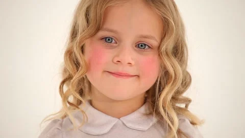 Close up shot of cute small nice little girl toddler child with curly blond hair Stockbeeldmateriaal 132674858