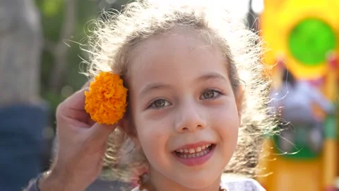 Close-up shot of an dad hands gently placing a vibrant orange marigold flow.. Stock Footage 320346605