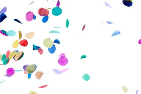 Close-up shot of decorative multi colored confetti falling against plain whit Stock Photos