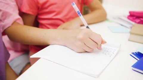 Close up shot of dedicated student writes intently on paper during a Stock Footage 281126095