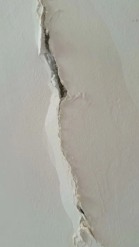 Close up shot of deep crack in white wall Video stock 331976642