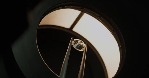 Close up shot of diamond under microscope held by tweezers Stock Footage 247372965