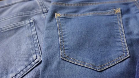 Close up shot of different shades of blue denim jeans back pockets. Stock Footage 201775635