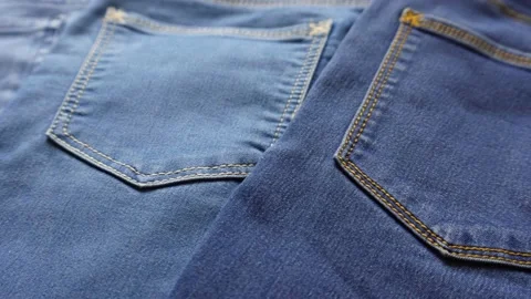 Close up shot of different shades of blue denim jeans back pockets. Stock Footage 201775656
