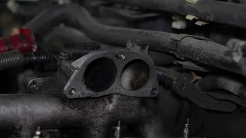 A close-up shot displays an open metallic intake manifold flange on a car eng Vídeo Stock 345108339