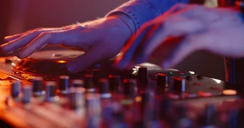 Close-up shot of dj's hands working on mixer controller, turning the knobs and 스톡 동영상 120267157