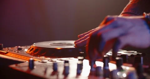 Close-up shot of dj's hands working on mixer controller, turning the knobs and 動画素材 120525998