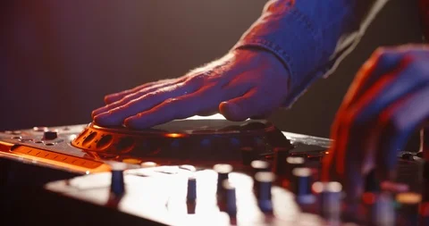 Close-up shot of dj's hands working on mixer controller, turning the knobs and 스톡 동영상 123541166