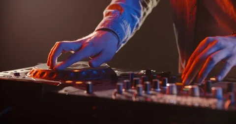 Close-up shot of dj's hands working on mixer controller, turning the knobs and 스톡 동영상 127136485