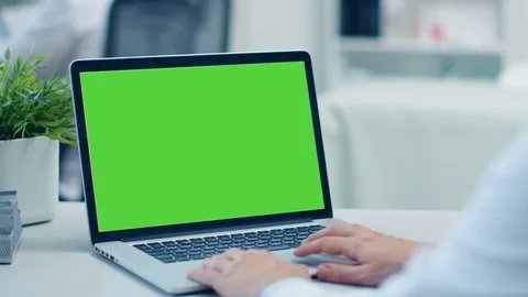 Close-up Shot of a Doctor Working on a Laptop with Green Screen On.  Stock Footage