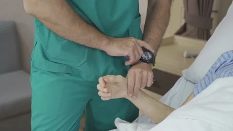 Close up shot of doctor's hand checking patient's pulse Stock Footage 156683631
