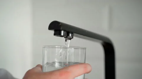 Close-up shot of drinking water being filled into a glass from the tap Stock Footage 153284372