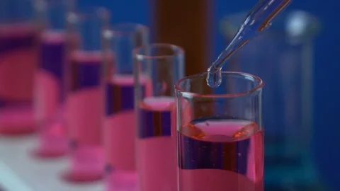 Close-up shot of dripping fluid into test tube Stock Footage 111305770