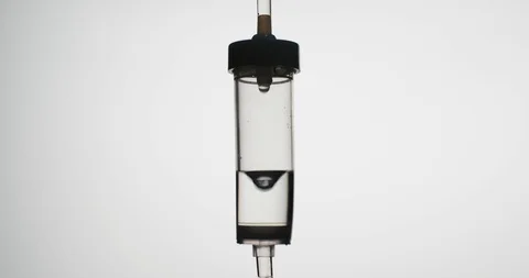 Close-up shot: Dropper. Liquid or saline slowly dripping in center of frame Stockbeeldmateriaal 126158900