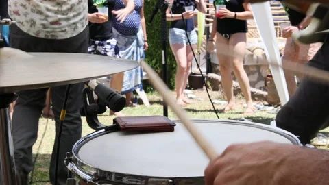 Close up shot of a drummer playing with his band at a summer party. Stock Footage 197290860
