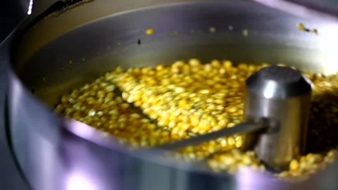 Close up shot of dry tiny corn seeds mixing with cheese sweet caramel flavoured  Stockbeeldmateriaal 137541542