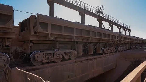 Close-up shot of dump car unloading ore at the crushing and sorting complex Stock Footage 75459534