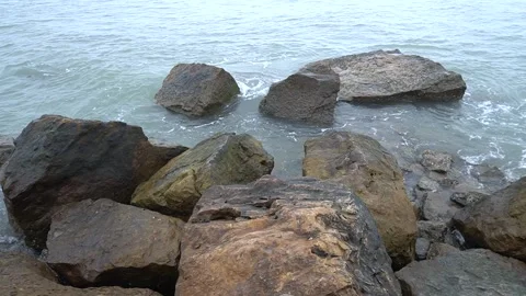 Close Up Shot of Dynamic Ocean Waves Splashing on Large Rugged Rocks Stock Footage 340481284