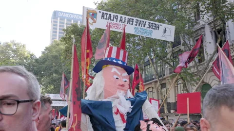 Close up shot of an effigy of uncle sam being carried by protestors Stock Footage 313994543