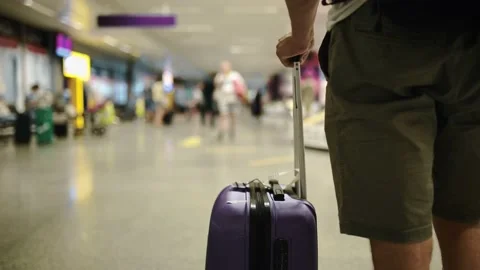 Close up shot of egs with the baggage walking to the airport terminal. Stock Footage 172328544