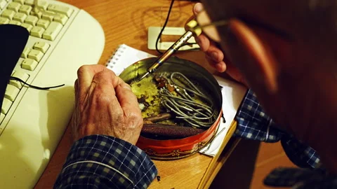 Close up shot of an elder man carefully soldering Video stock 327774066