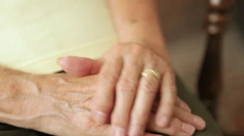 A close up shot of an elderly couple holding hands together. Stock Footage 50523024