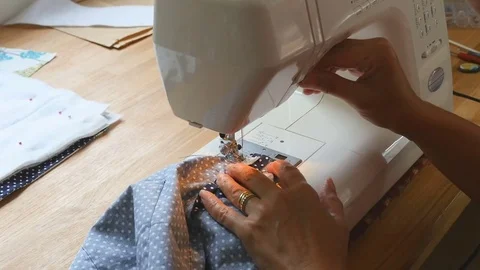 Close up shot of elderly female hands using sewing machine to stitch a bag Stock Footage 77114651