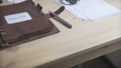 Close up shot of elegant light brown leather case note pad book daily planner bu Stock Footage 137538845