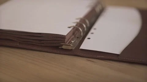 Close up shot of elegant light brown leather case daily planner organizer note p Stock Footage 137539218