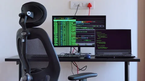Close shot of empty desk with hacker code being executed on the computer Stock Footage 146606350