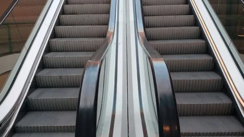 Close-up shot of empty moving staircase running up and down. Stock Footage 119074904