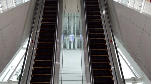 Close-up Shot of Empty Moving Staircase Running up and down Stock Footage 129908554