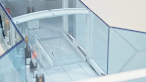 Close shot of an empty test tube in a holder moving along the line of an Stock Footage 234018968