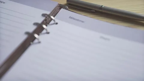 Close up shot of empty white paper lined pages of bullet journqal planner brown  Stock Footage 137539146