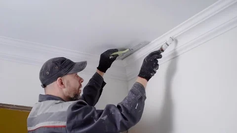 Close up shot of a experienced worker painting celling plinth Stock Footage 84097898