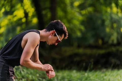 Close-up shot of an expert runner synchronizing his smartwatch before the start Stock Photos