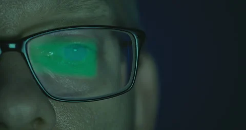 Close-up shot of eye in glasses of software engineer working on computer Stock Footage 245417920