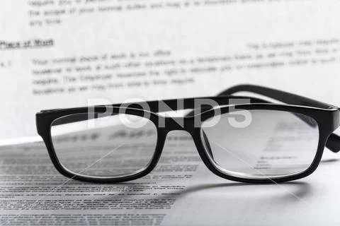 Close up shot of Eyeglasses on document papers business concept Stock Photos