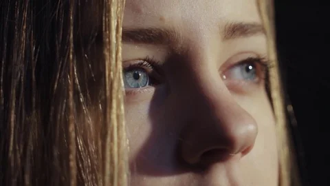Close up shot face young lonely sensual virgin european blue eyes girl room look Stock Footage 84643707