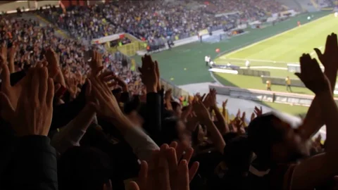 Close up shot of fans cheering supporting their football club at the stadi?m Stock Footage