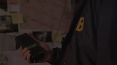Close up shot of FBI agent using old dictaphone Stock Footage 312455749